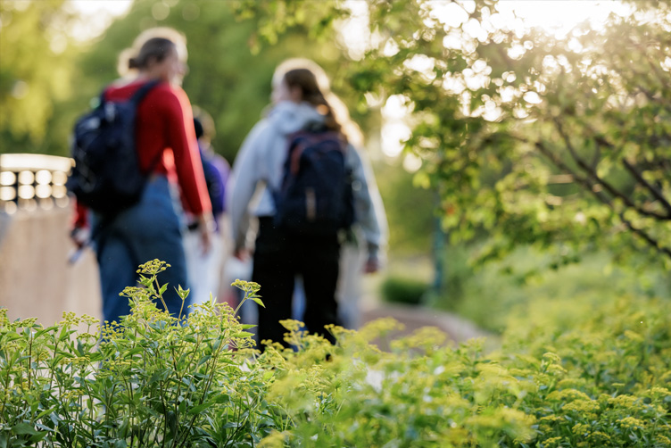 Students walk towards the South 40 underpass in the evening.